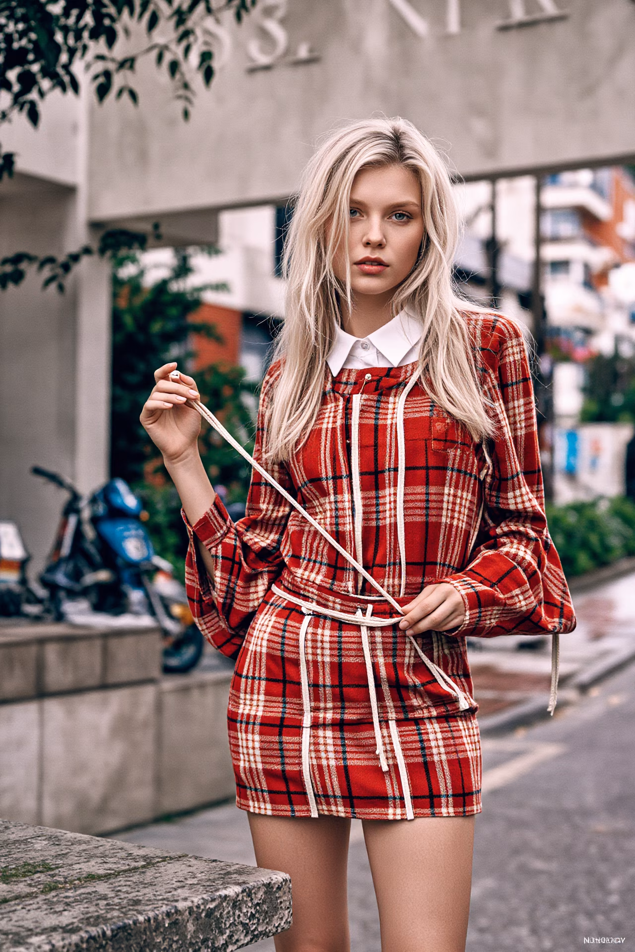 Close-up portrait of a young British woman with blonde hair and pink lips in fashionable attire, expressing love and charm.
