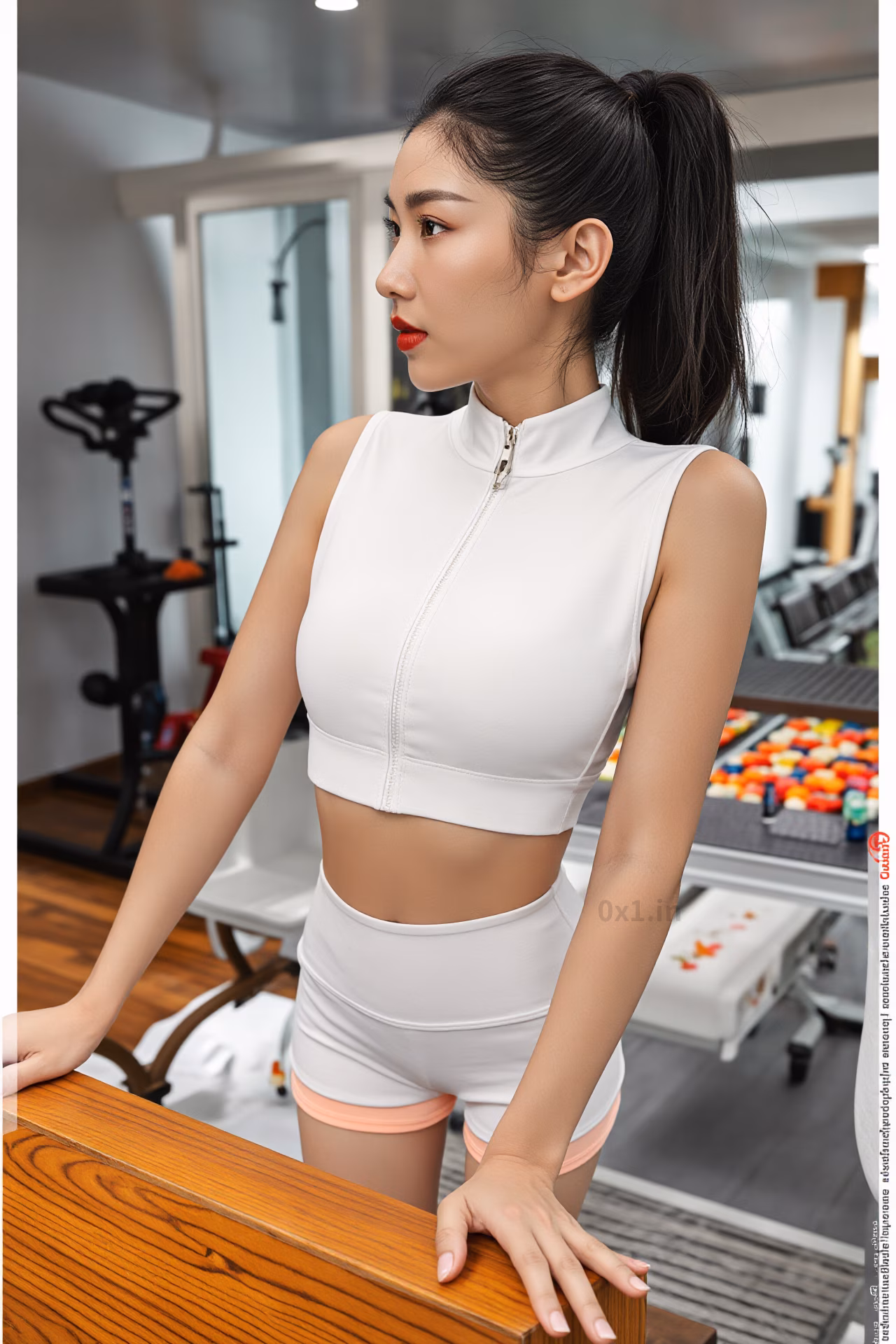 Close-up of a curvy Malaysian woman with long black hair and glossy red lips wearing a white workout crop top, expressing love.