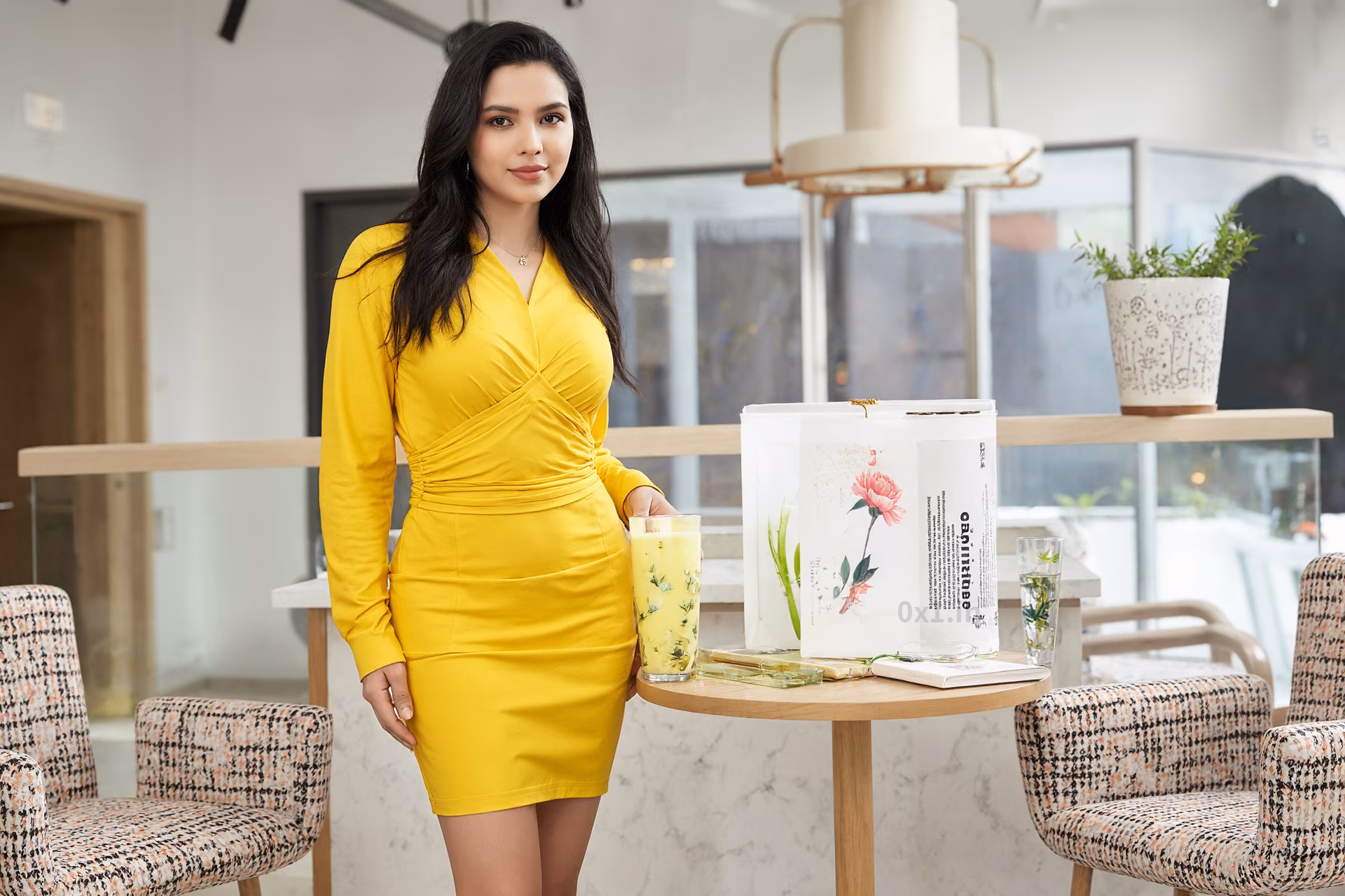 Close-up portrait of a slim Tajikistani woman in a yellow bodycon dress set in a modern hotel lobby.